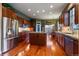 Well-lit kitchen boasting stainless steel appliances, a center island, and rich wood cabinetry at 4275 S Dawson St, Aurora, CO 80014