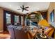 Spacious living room with a fireplace, ceiling fan, and hardwood flooring at 4275 S Dawson St, Aurora, CO 80014