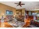 Bright living room with hardwood floors, sofas, a ceiling fan, and an open layout to the kitchen at 4275 S Dawson St, Aurora, CO 80014
