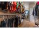 Large walk-in closet with clothing on rods, wire shelving, carpet flooring, and a doorway leading to another room at 4275 S Dawson St, Aurora, CO 80014