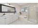 Beautiful bathroom with a double sink vanity, soaking tub, and glass-enclosed shower at 5129 Mt Arapaho Cir, Frederick, CO 80504