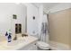 Well-lit bathroom featuring a clean vanity and a shower with patterned curtains at 5129 Mt Arapaho Cir, Frederick, CO 80504