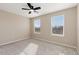 This bedroom has neutral walls, gray carpet and a ceiling fan at 5129 Mt Arapaho Cir, Frederick, CO 80504