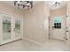 Welcoming foyer with tiled floors and French doors leading to a sunroom at 5129 Mt Arapaho Cir, Frederick, CO 80504