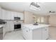 Bright kitchen features an island, stainless steel appliances, and ample white cabinets at 5129 Mt Arapaho Cir, Frederick, CO 80504