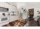 Bright kitchen with white cabinets, modern appliances, and an adjacent seating area at 5129 Mt Arapaho Cir, Frederick, CO 80504