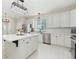 Modern kitchen featuring white cabinets, stainless steel appliances, and a central island with quartz countertops at 5129 Mt Arapaho Cir, Frederick, CO 80504