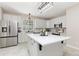 Bright kitchen with stainless steel appliances, quartz countertops, island, and ample cabinet space at 5129 Mt Arapaho Cir, Frederick, CO 80504