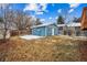 A detached, blue shed stands in the grassy, fenced backyard at 1430 Fairfax St, Denver, CO 80220