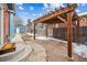 Backyard patio area featuring a pergola and brick pavers, perfect for outdoor relaxation at 1430 Fairfax St, Denver, CO 80220