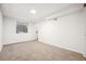 Finished carpeted basement space with a window well and natural light at 1430 Fairfax St, Denver, CO 80220