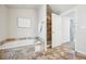 Bright bathroom features a soaking tub and a tiled walk-in shower at 1430 Fairfax St, Denver, CO 80220