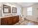 Bathroom featuring a double sink vanity with granite countertop and decorative tile flooring at 1430 Fairfax St, Denver, CO 80220