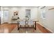 Dining area features hardwood floors, light grey chairs, and natural light at 1430 Fairfax St, Denver, CO 80220