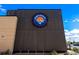 Signage of Denver Beer Co featuring scenic mountain logo on a modern brick and wood facade at 1430 Fairfax St, Denver, CO 80220