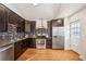 Modern kitchen boasts dark wood cabinets, stainless steel appliances, and stylish backsplash at 1430 Fairfax St, Denver, CO 80220