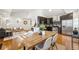 Open concept living room with hardwood floors and a view into the kitchen with stainless appliances at 1430 Fairfax St, Denver, CO 80220