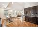 Open-concept living space with hardwood floors connects kitchen, living, and dining areas at 1430 Fairfax St, Denver, CO 80220