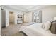 Bright main bedroom featuring a tray ceiling, balcony access, and carpeted floors at 1430 Fairfax St, Denver, CO 80220