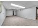 Unfinished basement space with carpet, white walls, and drop ceiling, ready for customization and storage at 2236 S Osceola St, Denver, CO 80219