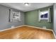 Comfortable bedroom featuring hardwood floors and two windows with natural lighting at 2236 S Osceola St, Denver, CO 80219