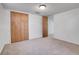 Carpeted bedroom with wood closet doors and neutral paint creates a cozy and inviting space at 2236 S Osceola St, Denver, CO 80219