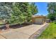 Front exterior of the home with attached garage and long driveway at 2236 S Osceola St, Denver, CO 80219