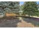 Front exterior of the home with mature landscaping and trees at 2236 S Osceola St, Denver, CO 80219