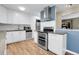 Updated kitchen with white cabinets, stainless steel appliances, and modern fixtures at 2236 S Osceola St, Denver, CO 80219
