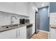 Kitchen featuring stainless steel appliances, white cabinets, and modern finishes at 2236 S Osceola St, Denver, CO 80219