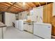 Basement laundry area with washer, dryer, sink, and extra freezer for storage solutions at 2236 S Osceola St, Denver, CO 80219