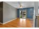 Bright living room featuring hardwood floors, a ceiling fan, and a sliding glass door to the outside at 2236 S Osceola St, Denver, CO 80219
