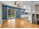 Living room with hardwood floors transitions into a kitchen with white cabinets and stainless steel appliances at 2236 S Osceola St, Denver, CO 80219