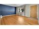 Living room with hardwood floors, blue accent wall, and natural light at 2236 S Osceola St, Denver, CO 80219