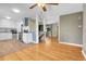 Open concept living space with a kitchen, hardwood floors, stainless appliances, and a staircase at 2236 S Osceola St, Denver, CO 80219