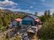 Aerial view of the property featuring log homes, a sunroom, a deck, and stunning mountain views at 3945 Douglas Mountain Dr, Golden, CO 80403