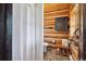 Rustic bathroom with log walls, wooden accents, a shower, and convenient storage at 3945 Douglas Mountain Dr, Golden, CO 80403