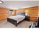 Cozy bedroom featuring log walls, a large bed, and ample lighting at 3945 Douglas Mountain Dr, Golden, CO 80403