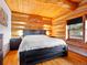 Charming bedroom with wood paneling, hardwood floors and mountain decor at 3945 Douglas Mountain Dr, Golden, CO 80403