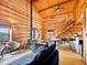 Cozy living room featuring wood burning stove, hardwood floors and wood paneling at 3945 Douglas Mountain Dr, Golden, CO 80403