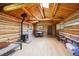 Cozy living room features a wood-burning stove, rustic wood walls, and flooring, creating a warm and inviting atmosphere at 3945 Douglas Mountain Dr, Golden, CO 80403