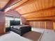 Lofted main bedroom with log walls, spacious layout, and built-in storage at 3945 Douglas Mountain Dr, Golden, CO 80403