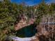 Secluded mountain pond surrounded by evergreens and other natural vegetation at 3945 Douglas Mountain Dr, Golden, CO 80403