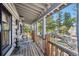 Charming porch with wooden railings, rocking chairs, and scenic mountain views at 3945 Douglas Mountain Dr, Golden, CO 80403