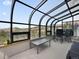 Enclosed sunroom with glass ceilings, offering views of the surrounding landscape at 3945 Douglas Mountain Dr, Golden, CO 80403