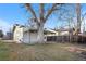 Backyard featuring a covered patio, lawn, large tree, and privacy fence perfect for outdoor enjoyment at 4518 Elm Ct, Denver, CO 80211