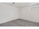 An empty room with gray carpet and small window, ready for customization at 4518 Elm Ct, Denver, CO 80211