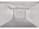 An empty room with gray carpet, ready for customization at 4518 Elm Ct, Denver, CO 80211