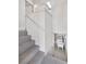 Carpeted basement stairs leading to a laundry area at 4518 Elm Ct, Denver, CO 80211