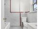 Compact bathroom with a tiled shower-tub combination, toilet, and sink at 4518 Elm Ct, Denver, CO 80211